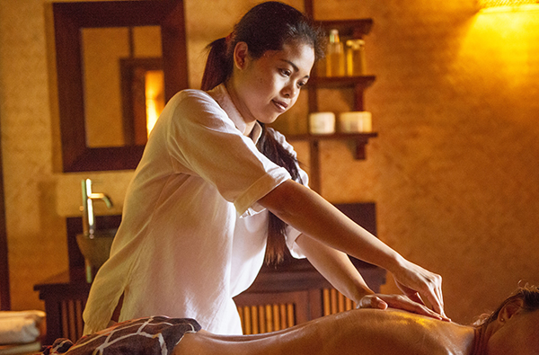 Laluna's alinese therapist giving the signature Balinese massage to a hotel guest
