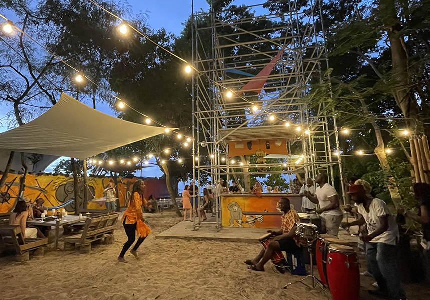 The Monkey Bar, Beach bar Grenada with people dancing and drumming